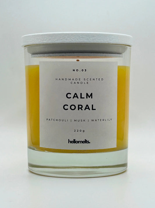 Calm Coral 220g candle, with lid on, by Hellomelts, blending patchouli with soothing scents of musk and a touch of waterlily, in a bright yellow wax.
