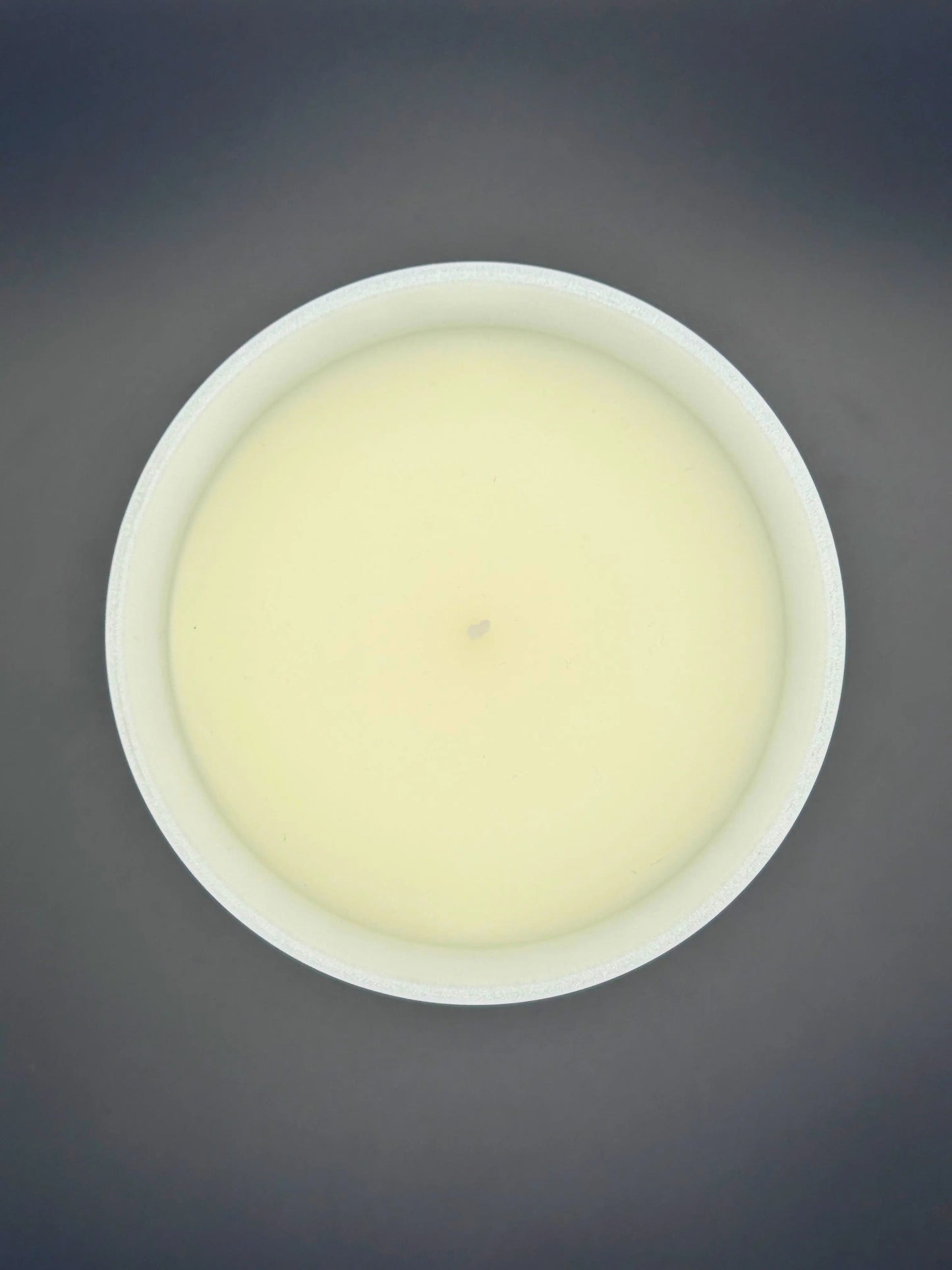 Spiced Gingerbread 220g candle, by Hellomelts, showing top view of candle wax, rich with scents of cinnamon, gingerbread, and caramel, presented in a white matt jar with wooden lid.