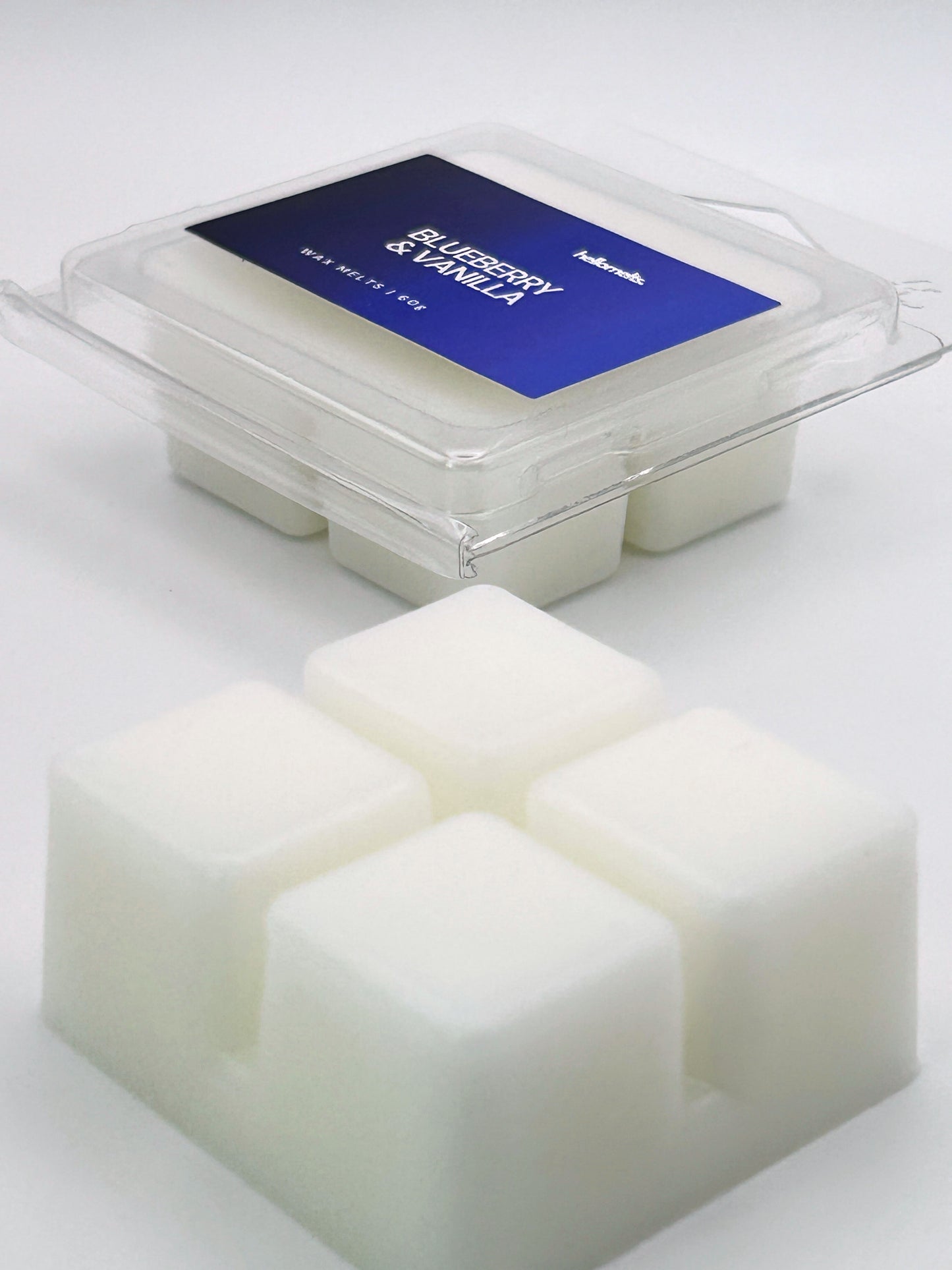 Angled shot of Blueberry & Vanilla 60g wax melt bar in front of its packaging, part of the fruity Summer Collection by Hellomelts