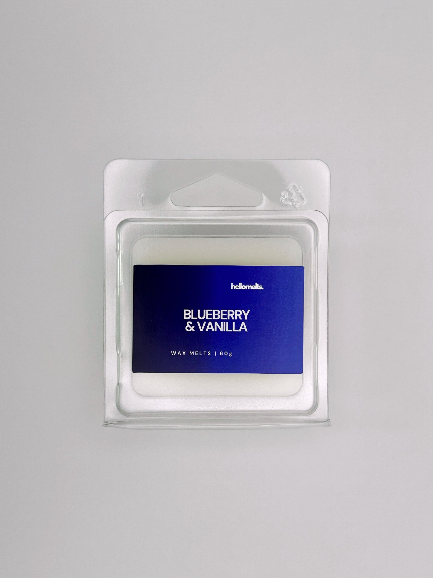 Flatlay of Blueberry & Vanilla 60g wax melt bar by Hellomelts, part of the Summer Collection with deep blue label colours and smooth wax finish