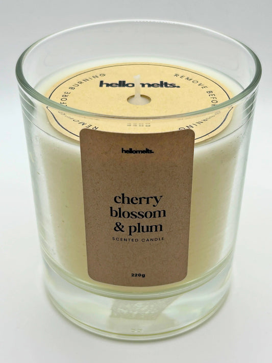Angled front view of the Cherry Blossom & Plum candle with the branded cardboard wick cover on, from the Hellomelts Spring Collection.