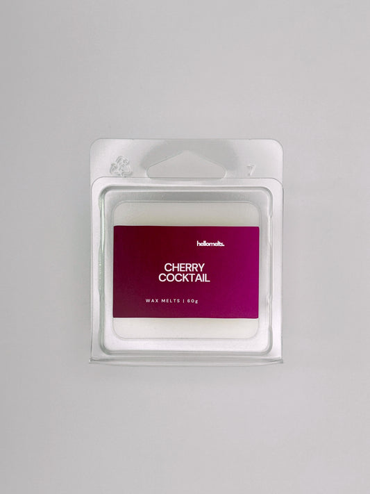 Flatlay of Cherry Cocktail 60g wax melt bar by Hellomelts, part of the Summer Collection with bold red label and fruity cocktail theme