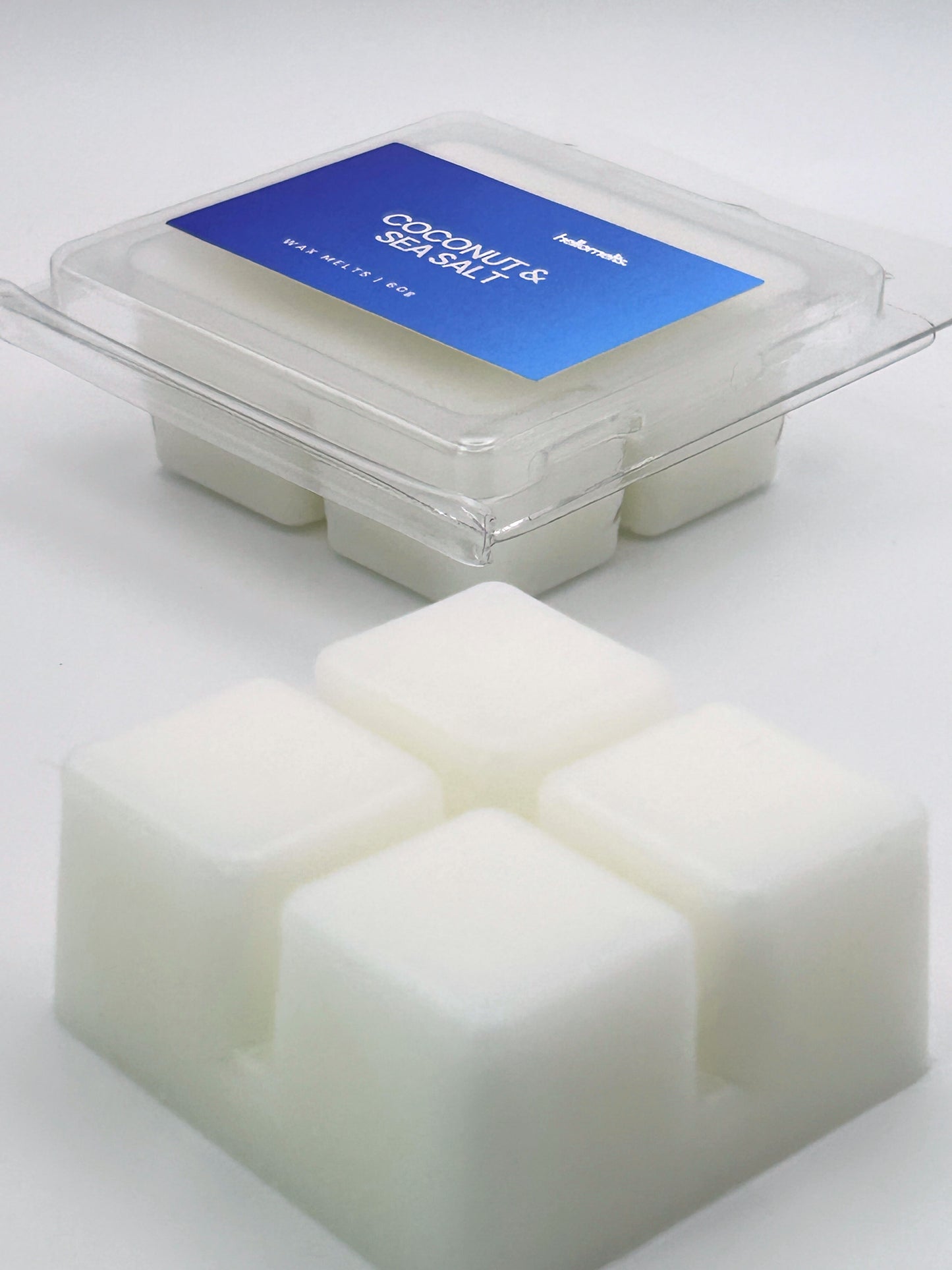 Angled shot of Coconut & Sea Salt 60g wax melt bar in front of its packaging, part of the Summer Collection by Hellomelts