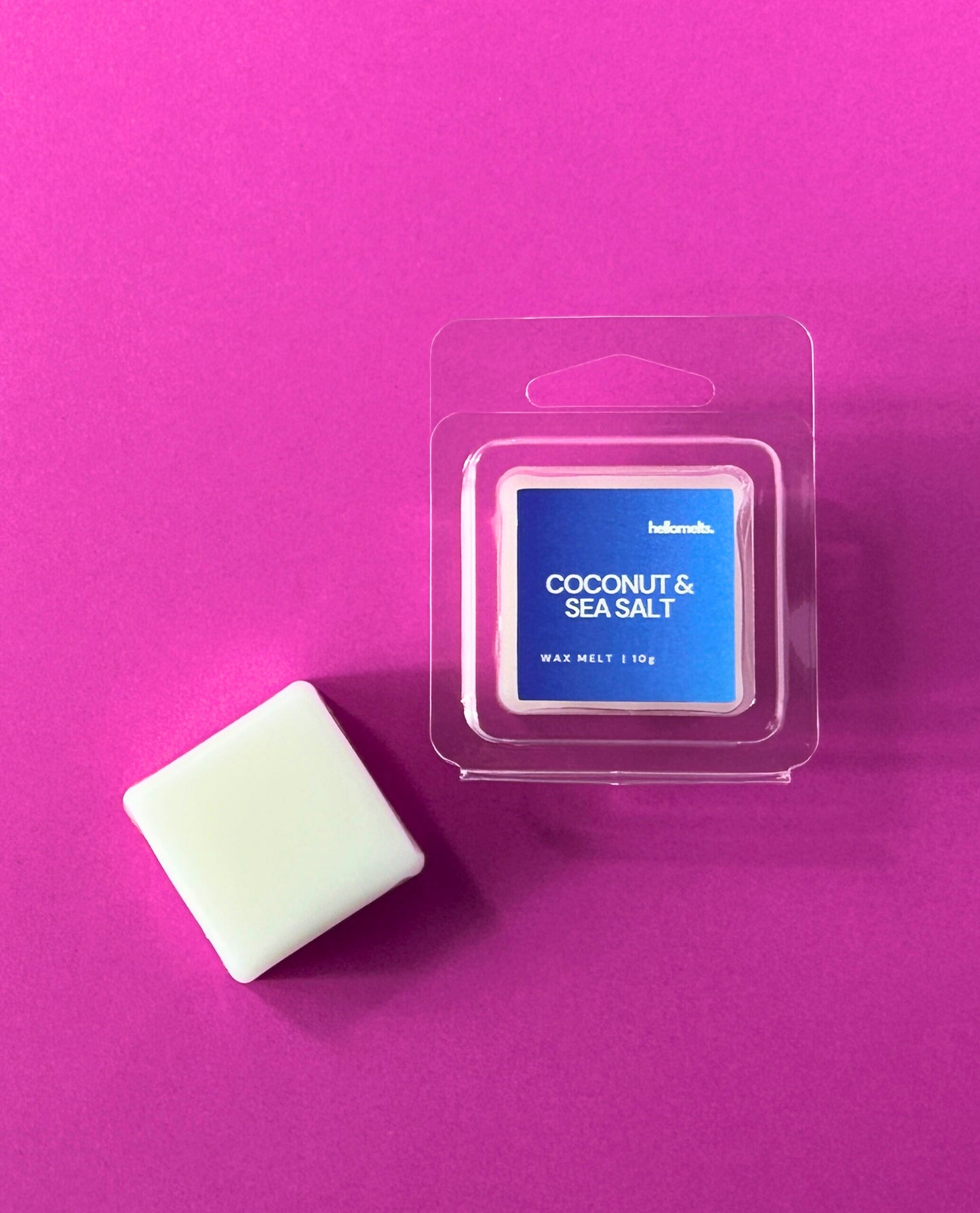 Hellomelts Coconut & Sea Salt free 10g wax melt sample in clamshell packaging with cube, part of the Summer Collection, displayed on pink background