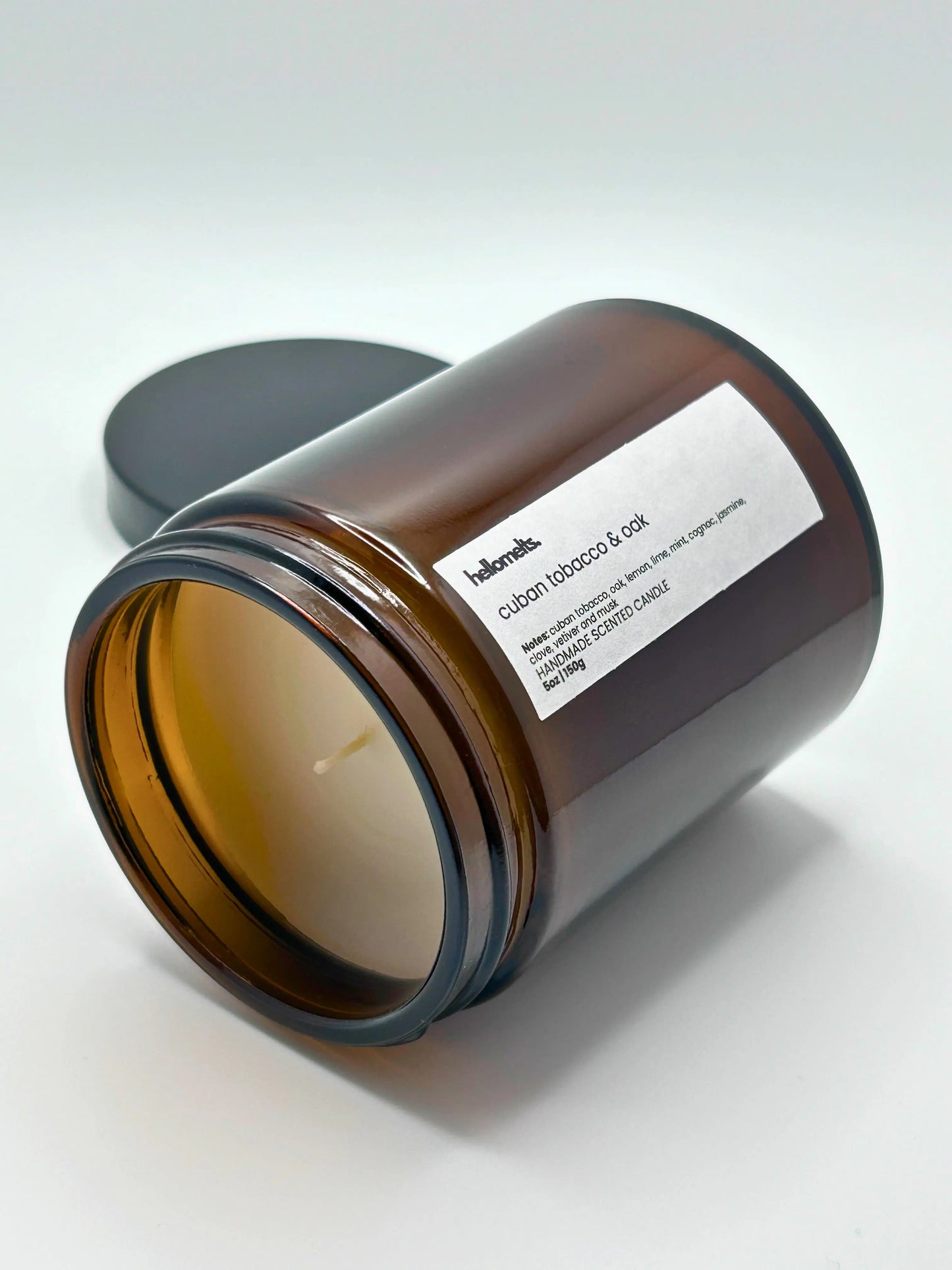 Cuban Tobacco & Oak candle by Hellomelts lying down with the wick facing forward, part of the autumn collection.