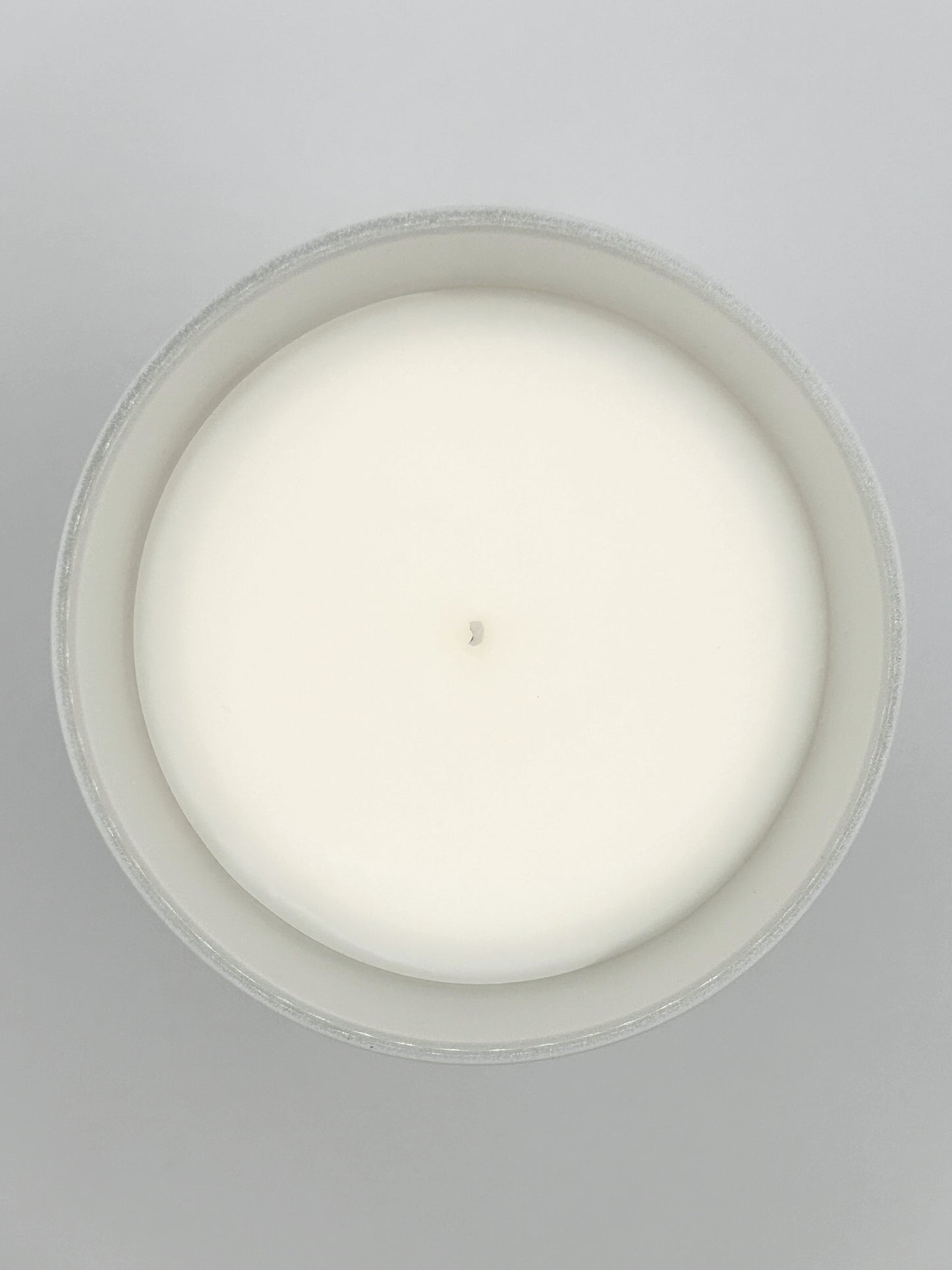 Frankincense & Myrrh 220g candle close-up top-down image showing the wax surface and centred wick from the Hellomelts Winter Collection