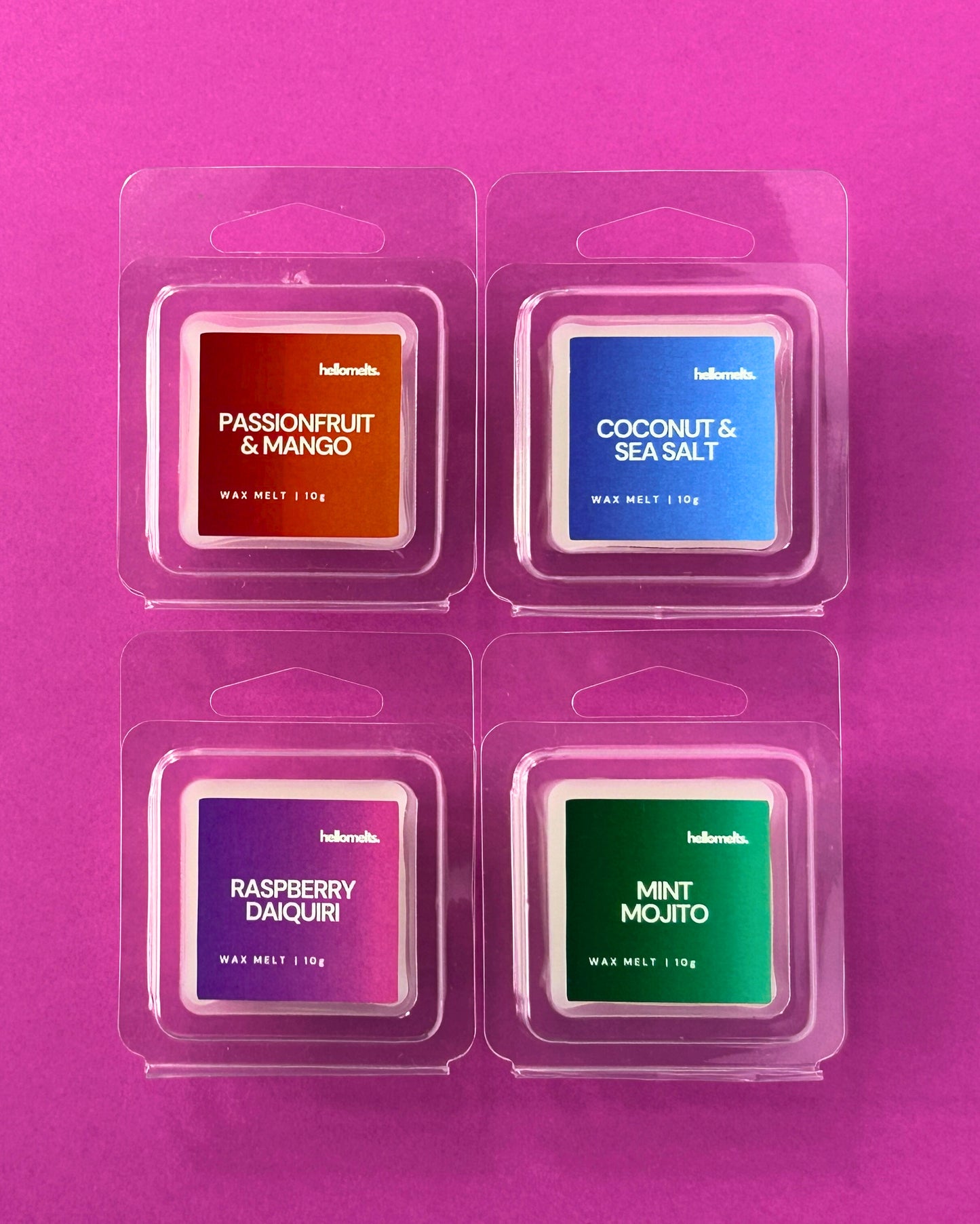 Set of free 10g wax melt samples in clamshell packaging from Hellomelts Summer Collection, featuring Passionfruit & Mango, Coconut & Sea Salt, Raspberry Daiquiri, and Mint Mojito, displayed on a pink background
