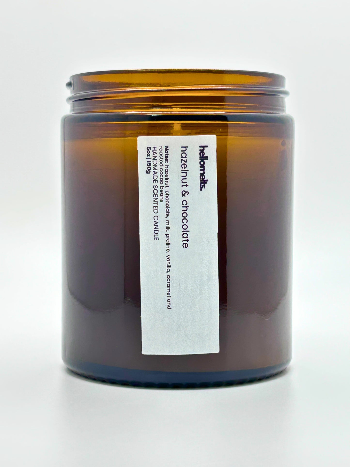 Top-down view of Hazelnut & Chocolate autumn candle by Hellomelts, highlighting the wick and hand-poured wax in an amber jar, part of the Autumn Collection