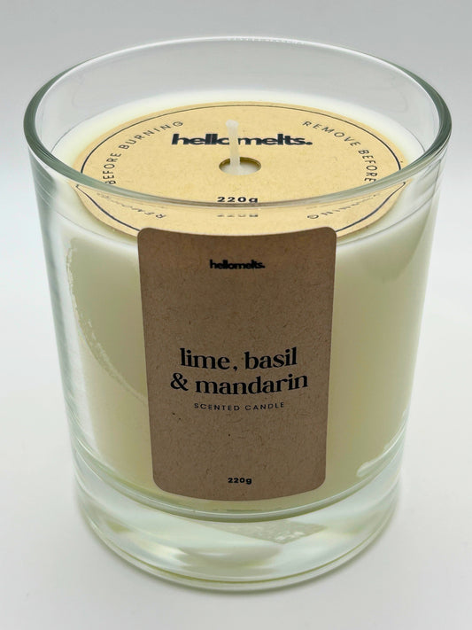 Angled front view of the Lime, Basil & Mandarin candle with the branded cardboard wick cover on, from the Hellomelts Spring Collection.