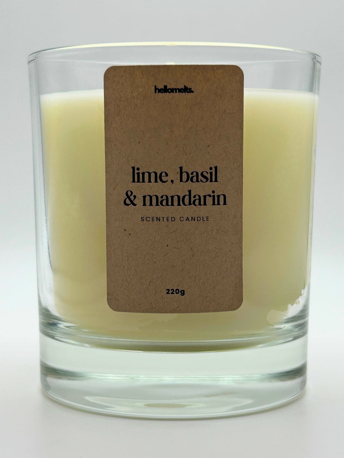 Close-up of the Lime, Basil & Mandarin candle label showing scent name and weight, a handcrafted candle by Hellomelts for the Spring Collection.