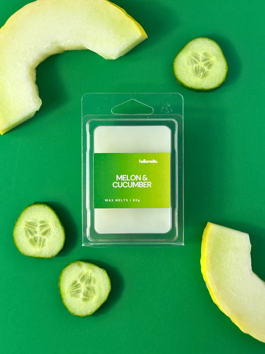 Melon & Cucumber wax melt bar by Hellomelts, styled on a green background with fresh cucumber slices and melon pieces, part of the Summer Collection