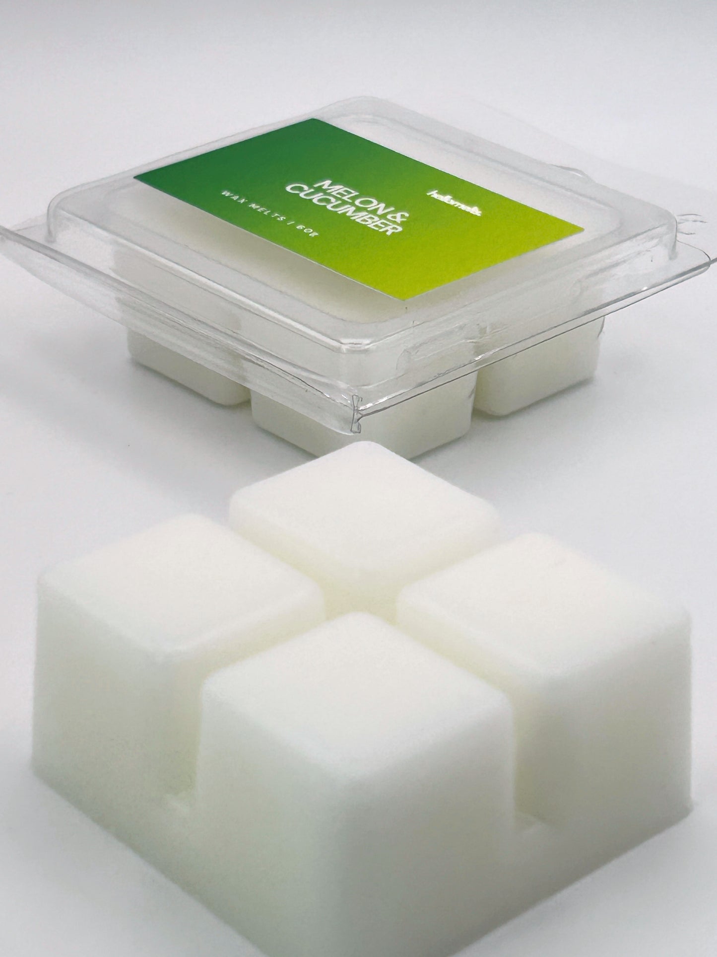 Angled shot of Melon & Cucumber 60g wax melt bar in front of its packaging, part of the Summer Collection by Hellomelts