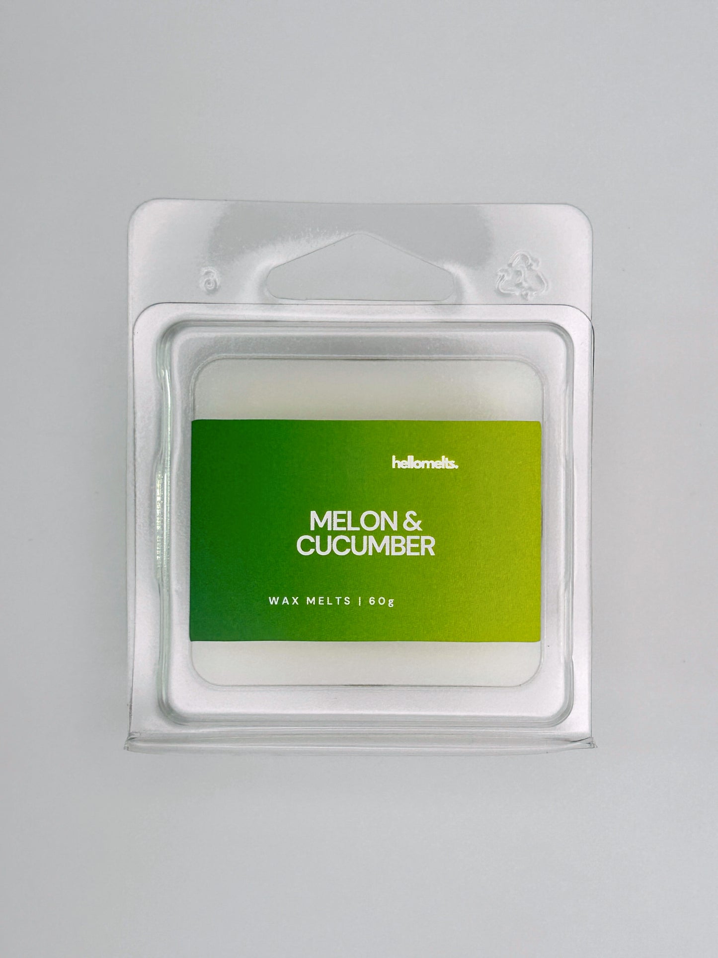 Close-up front view of Melon & Cucumber 60g wax melt bar by Hellomelts, showing smooth wax surface and bold green label