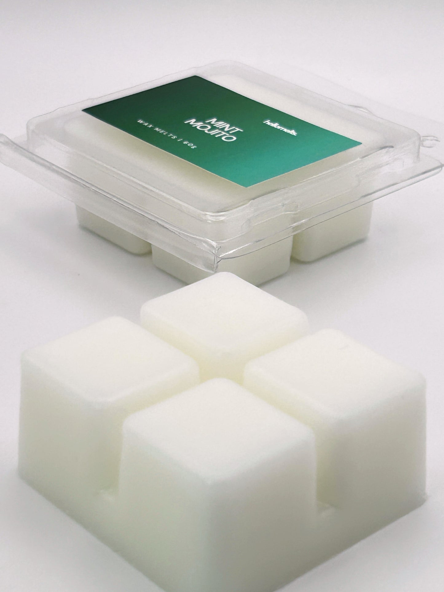 Angled shot of Mint Mojito 60g wax melt bar in front of its packaging, part of the Summer Collection by Hellomelts