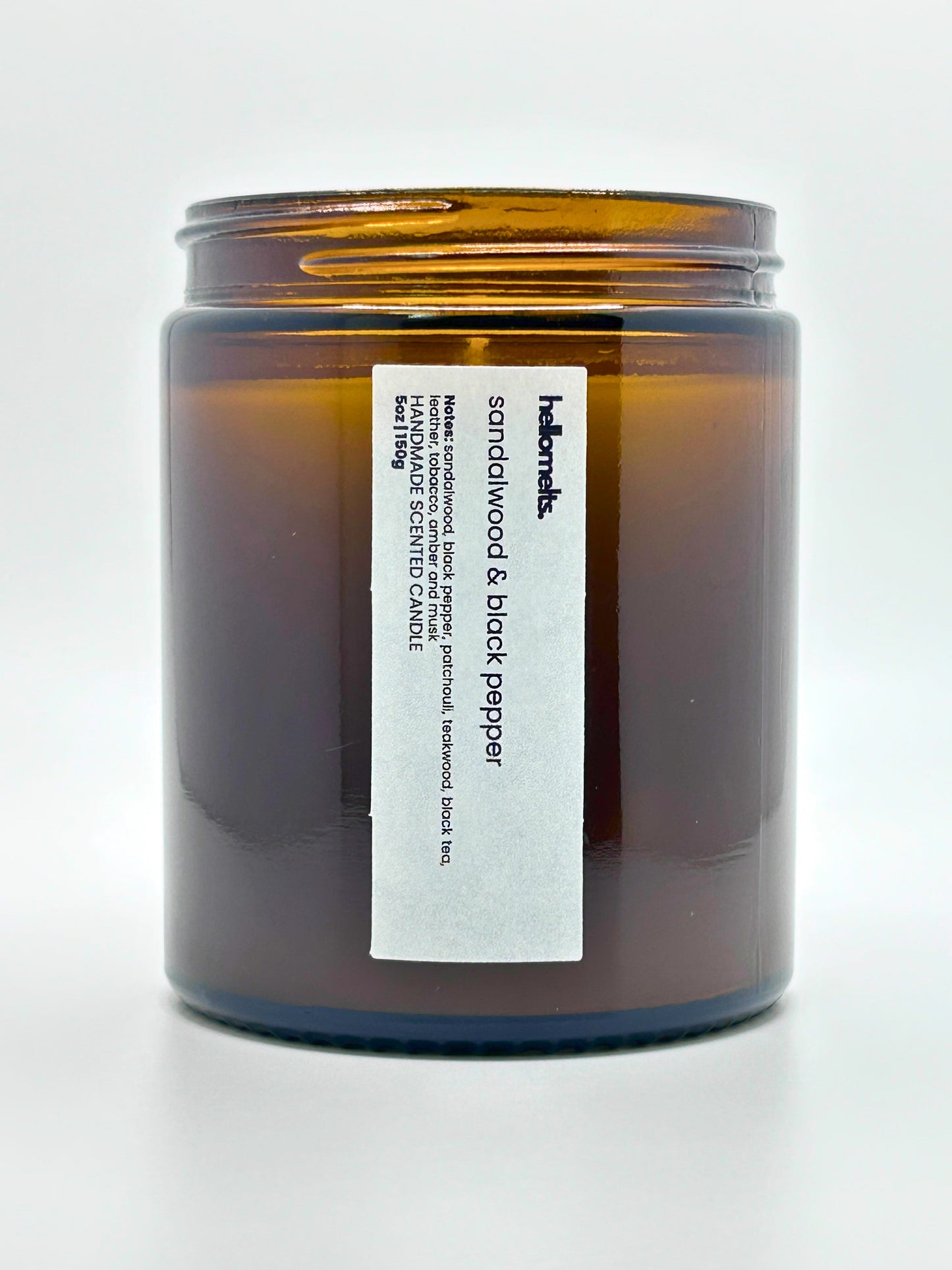 Close-up front view of Sandalwood & Black Pepper autumn scented candle by Hellomelts with the lid off, part of the Autumn Collection