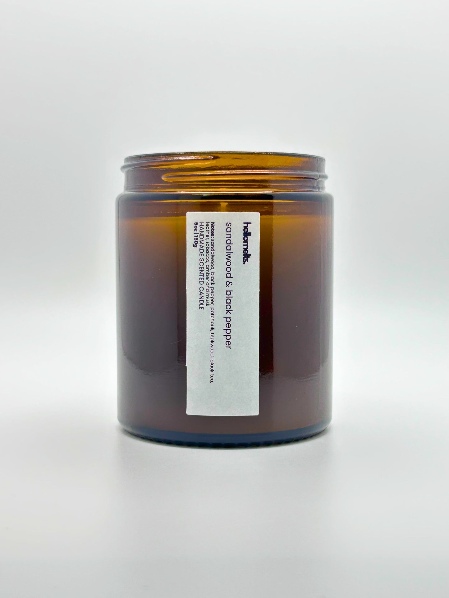 Front view of Sandalwood & Black Pepper autumn scented candle by Hellomelts with the lid off, part of the Autumn Collection