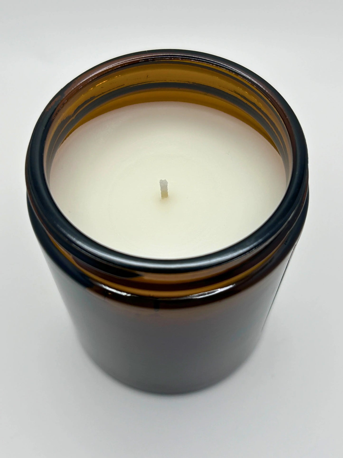 Angled top view of Sandalwood & Black Pepper candle by Hellomelts, part of the autumn collection, highlighting the hand-poured wax.