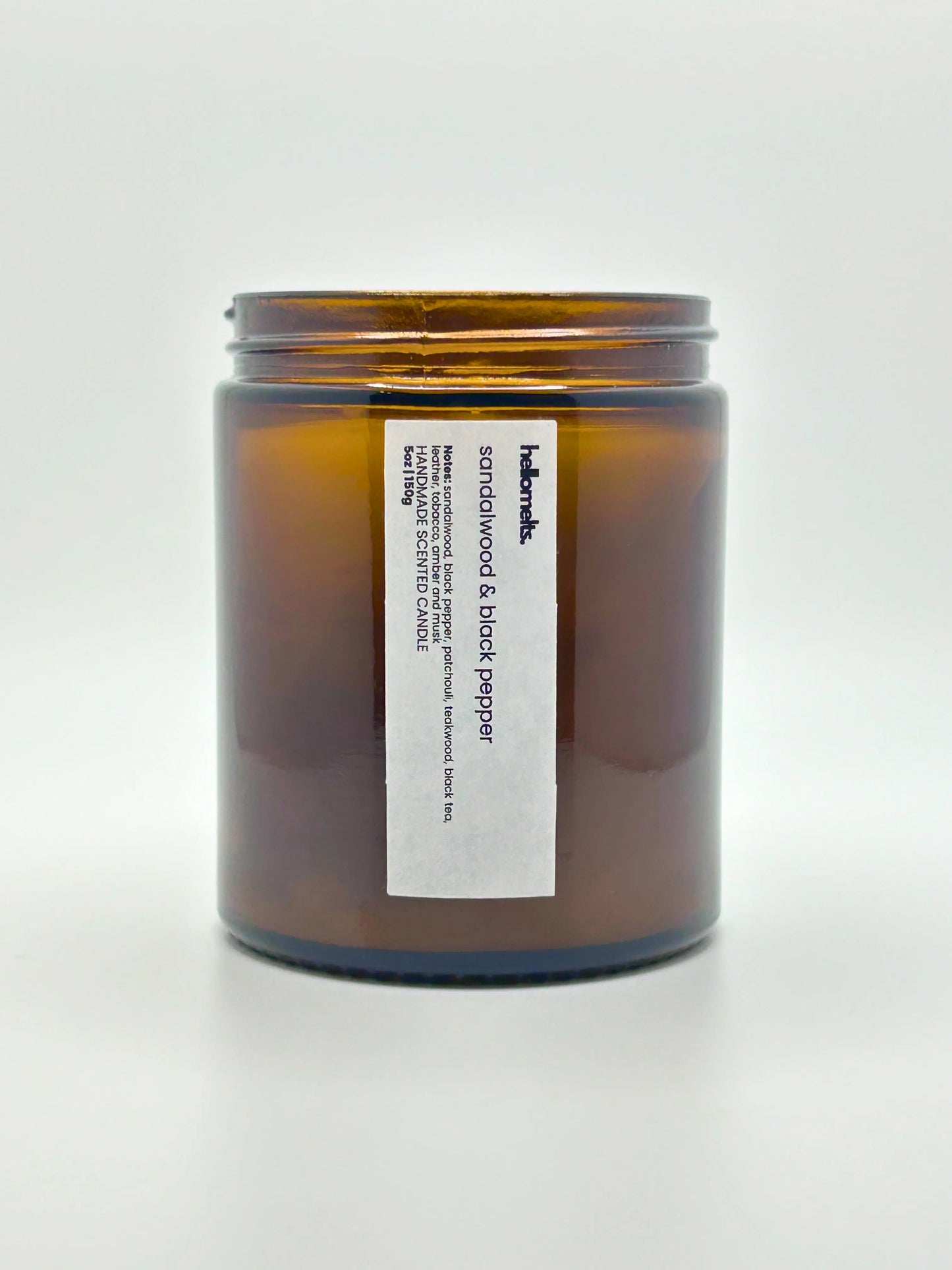 Front view of Sandalwood & Black Pepper candle by Hellomelts with the lid off, showing the hand-poured wax, from the autumn collection.