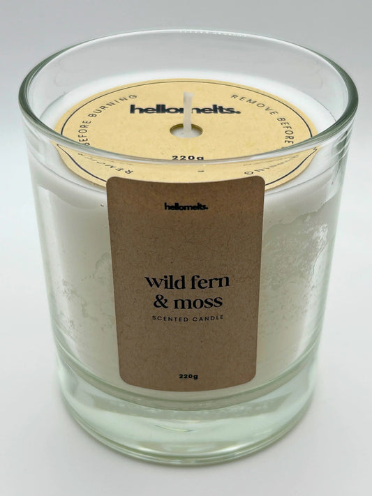 Angled front view of the Wild Fern & Moss candle with the branded cardboard wick cover on, from the Hellomelts Spring Collection.