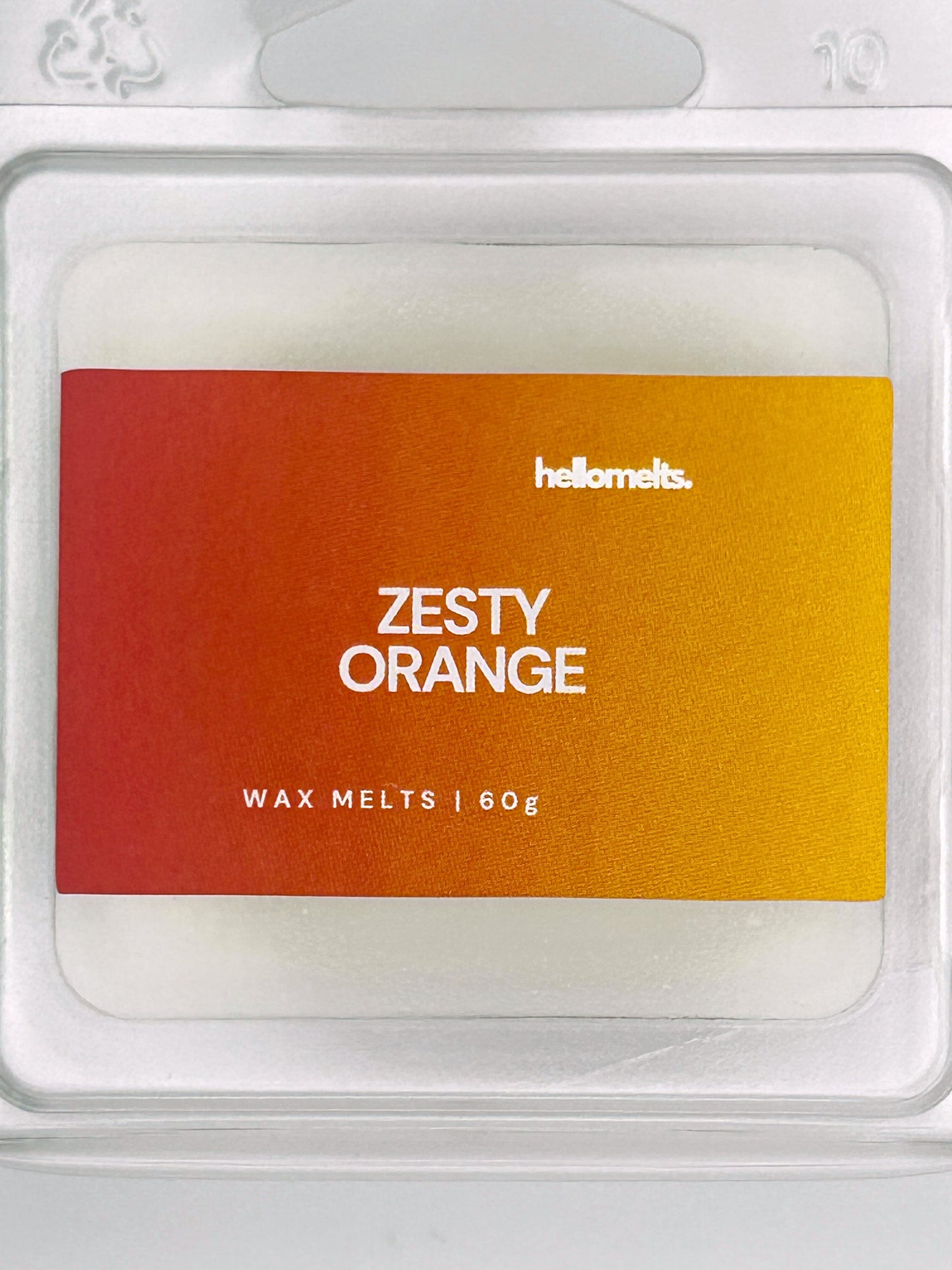 Close-up of the Zesty Orange 60g wax melt label, showing detailed branding and refreshing citrus scent design from Hellomelts