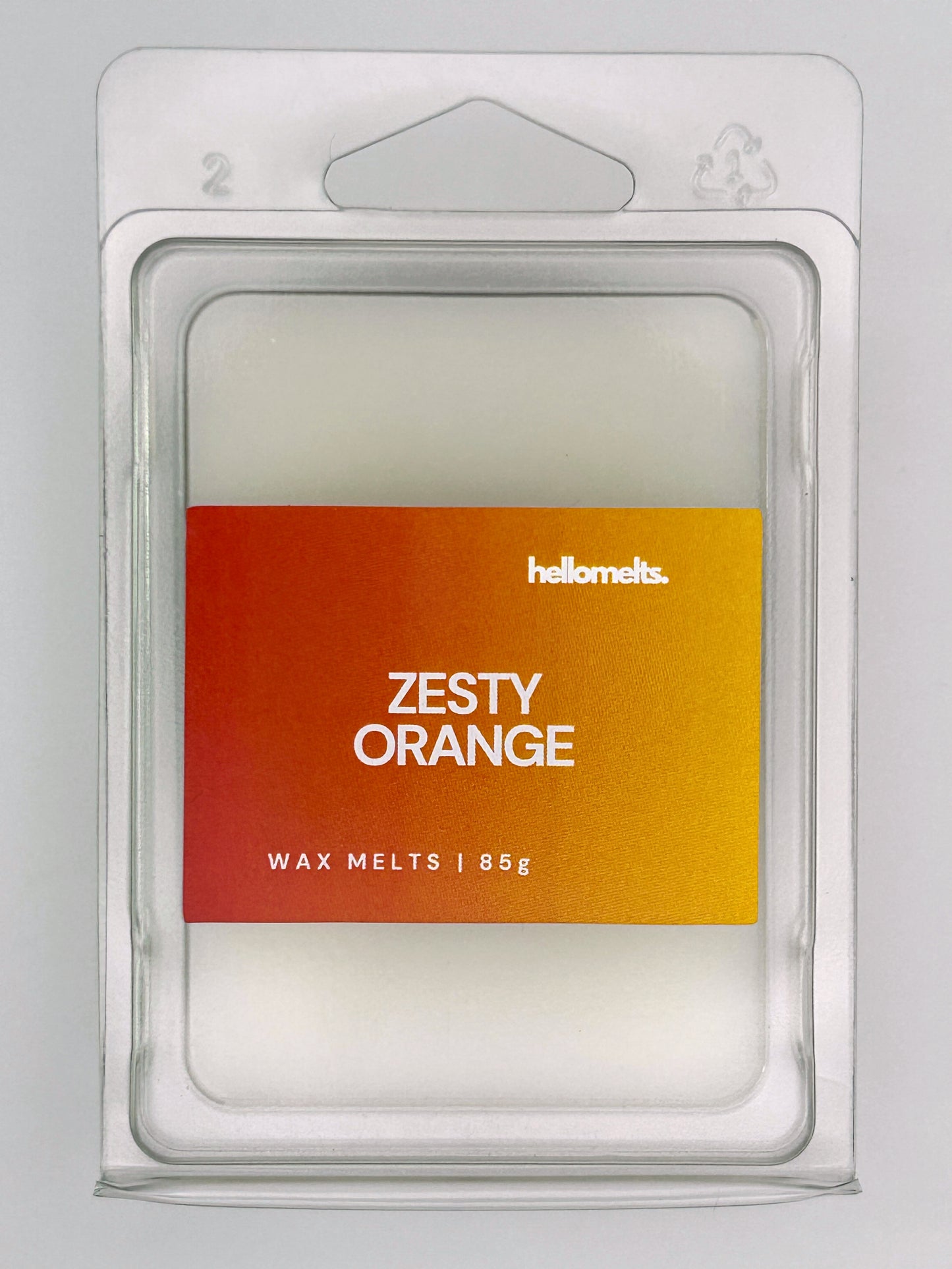 Close-up front view of Zesty Orange 85g wax melt bar by Hellomelts, showing wax texture and citrus orange label