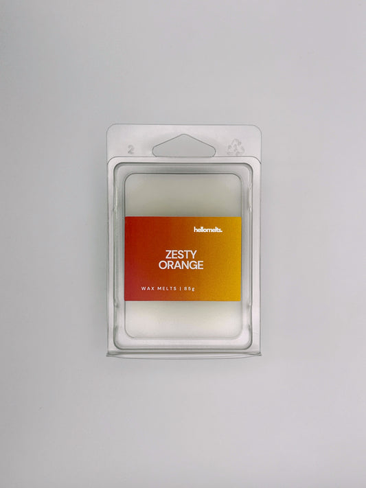 Flatlay of Zesty Orange 85g wax melt bar by Hellomelts, part of the Summer Collection with bold orange tones and fresh summer design
