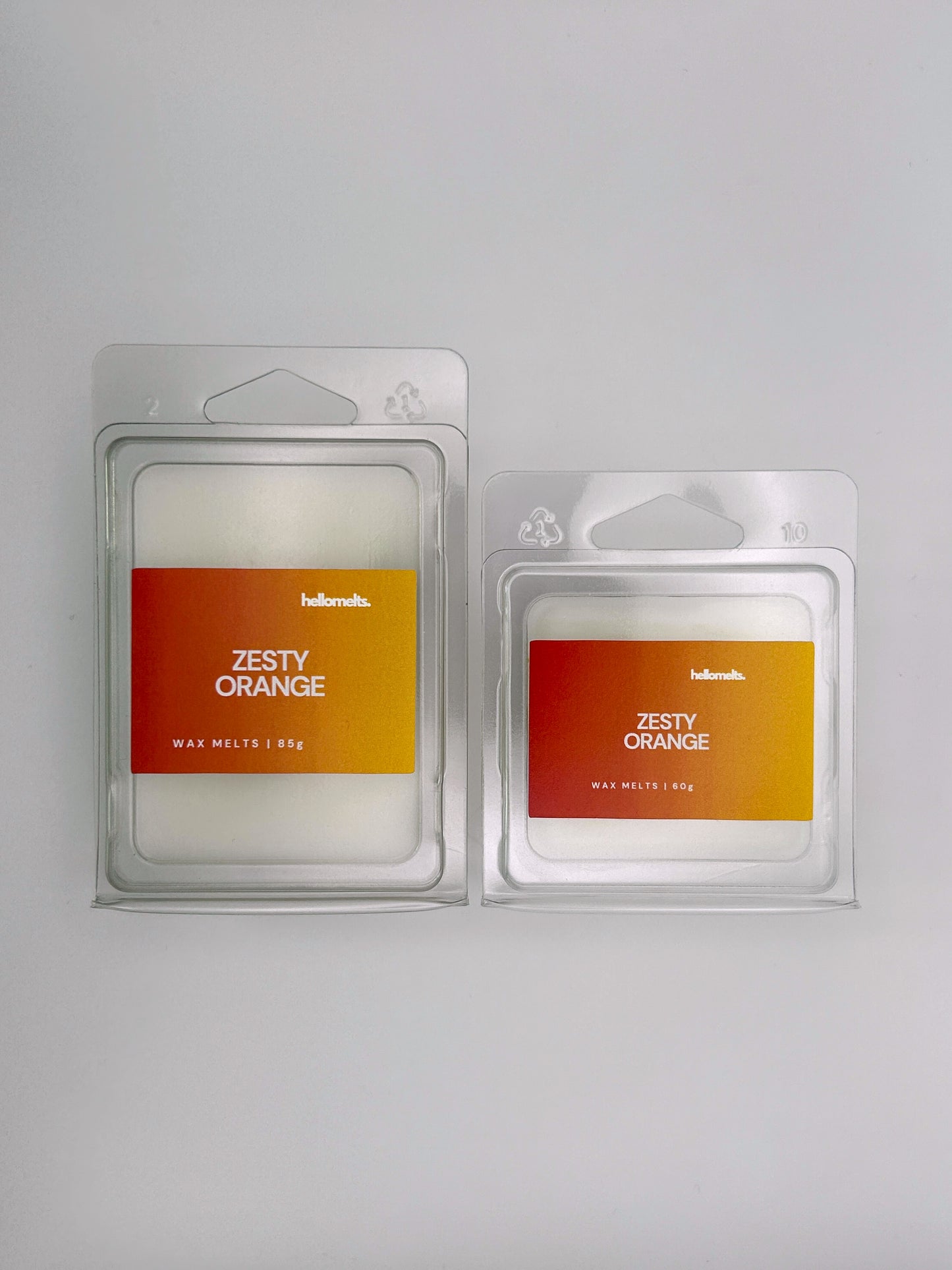 Side-by-side view of Hellomelts Zesty Orange wax melts in both 85g and 60g sizes from the Summer Collection