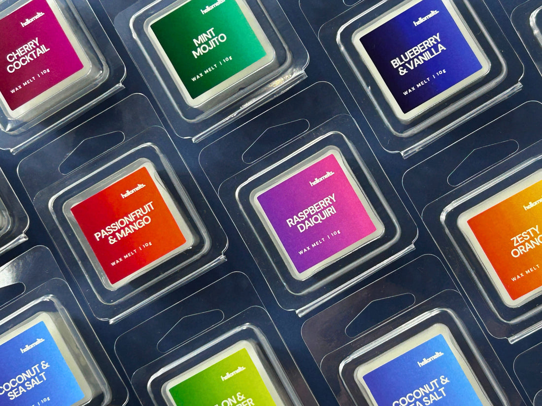 Flatlay of Hellomelts Free Wax Melt Samples from the 2025 Summer Collection, including scents like Passionfruit & Mango, Raspberry Daiquiri, Blueberry & Vanilla and Coconut & Sea Salt in eco-friendly 10g clamshells