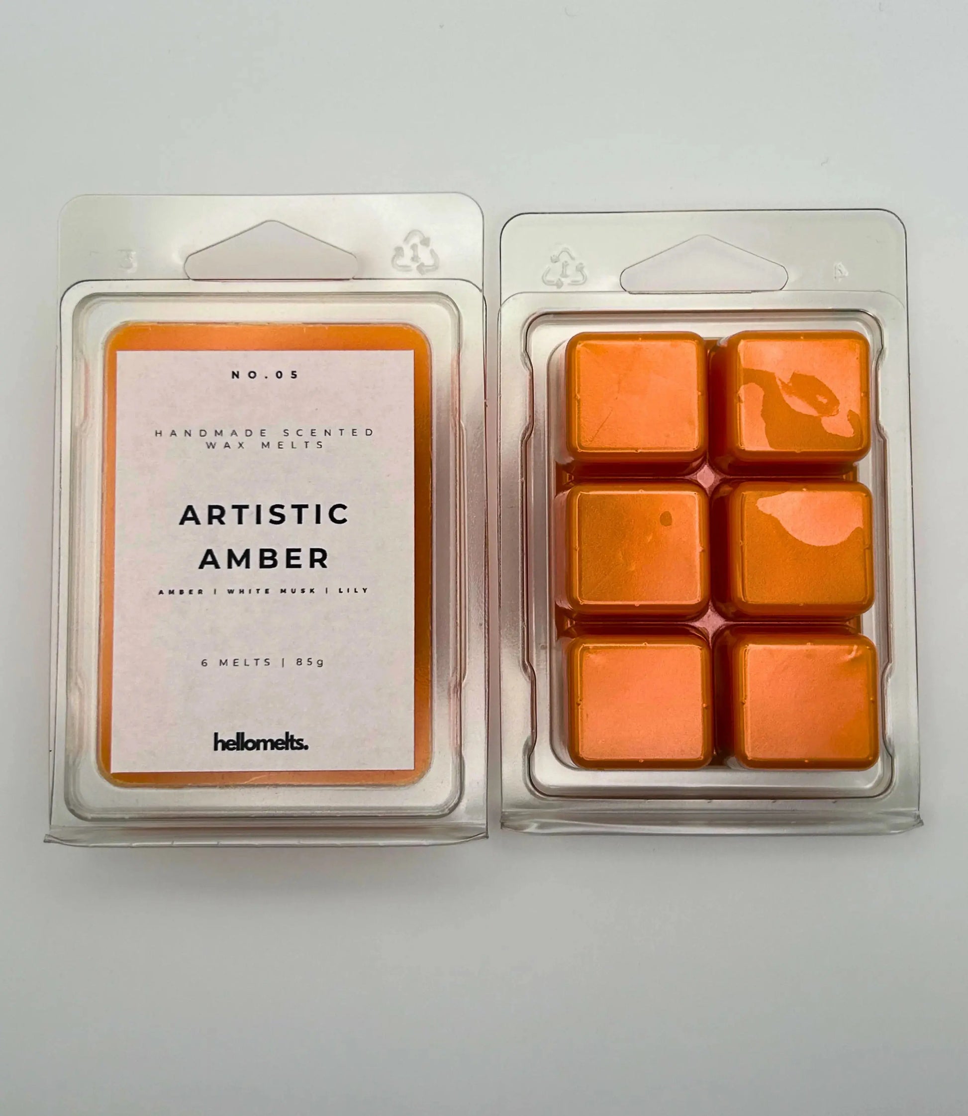 Artistic Amber 85g wax melt pack, front & back view, by Hellomelts, infused with notes of amber, white musk, and lily, ready to fragrance your home.