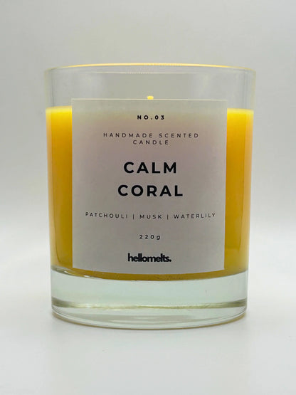 Calm Coral 220g candle, with no lid, by Hellomelts, blending patchouli with soothing scents of musk and a touch of waterlily, in a bright yellow wax.