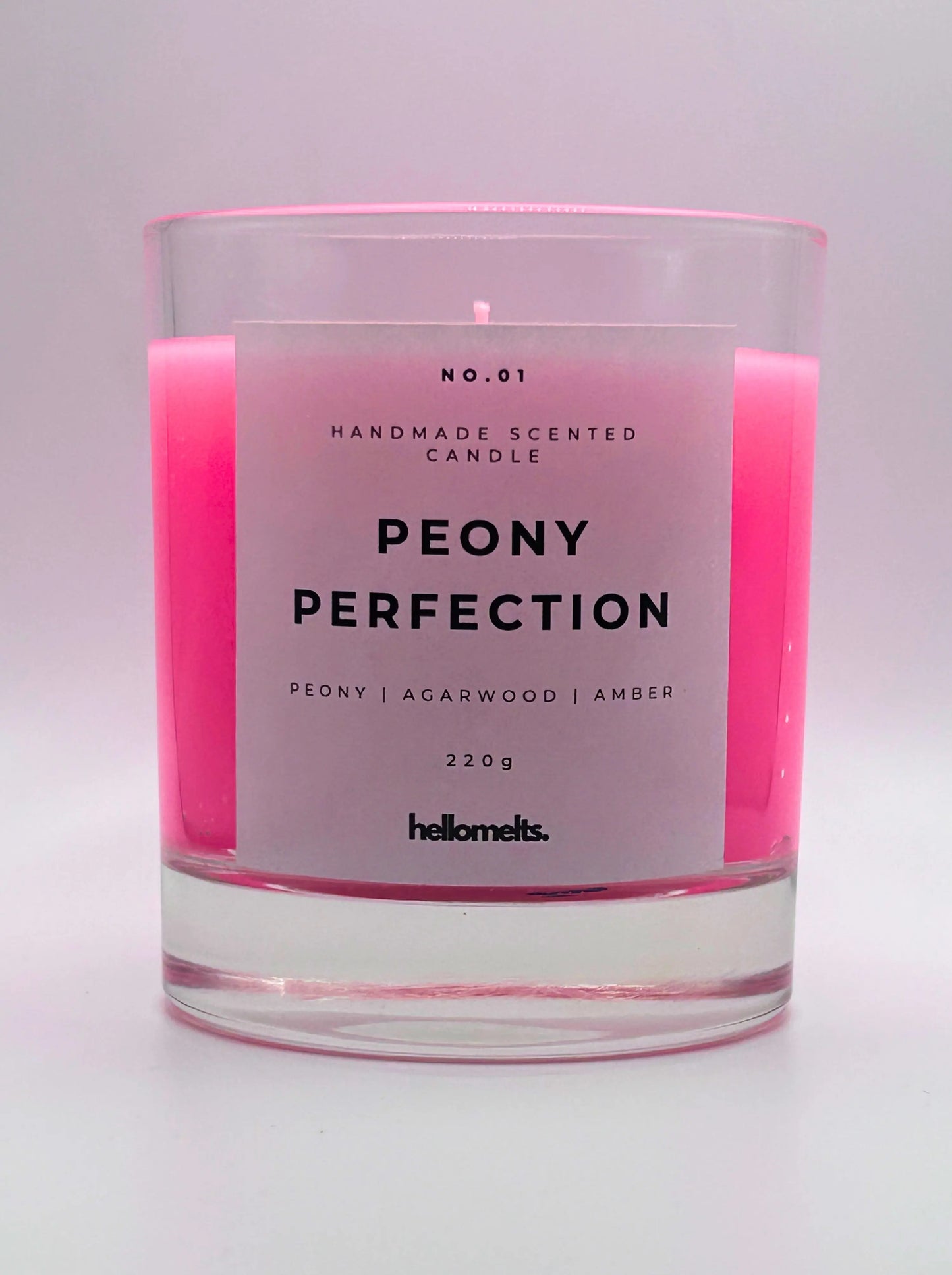 Peony Perfection 220g candle, with no lid, by Hellomelts, exuding delicate peony, luxurious agarwood, and warm amber aromas, in a beautiful bright pink wax.