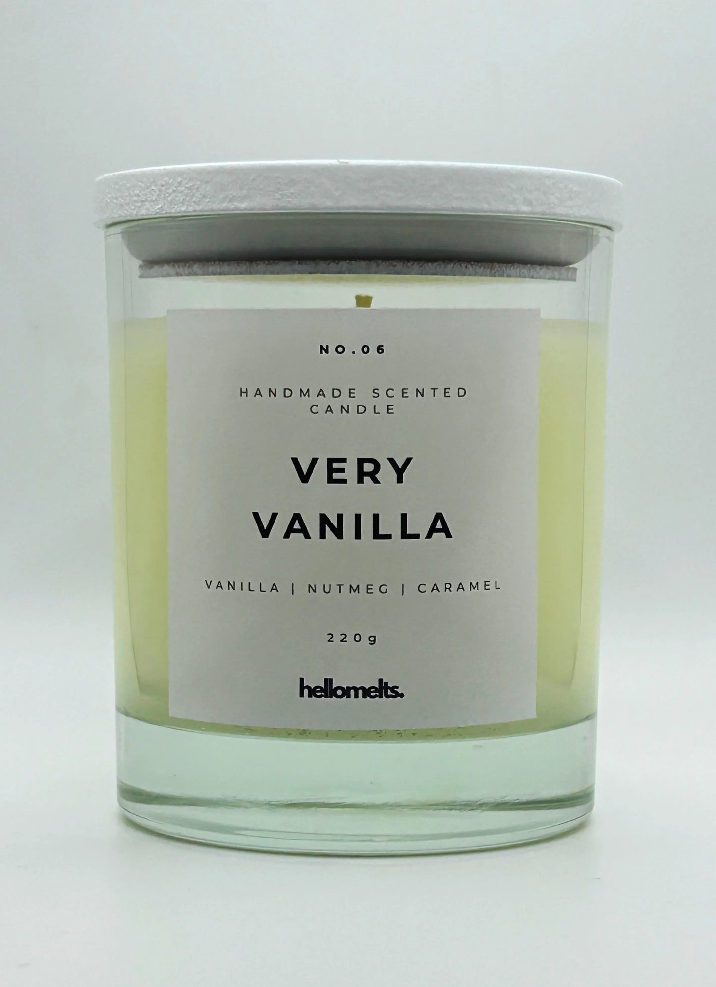 Very Vanilla 220g candle by Hellomelts, with lid on, infused with the warm scents of vanilla, nutmeg, and caramel, showcased in a simple white wax.