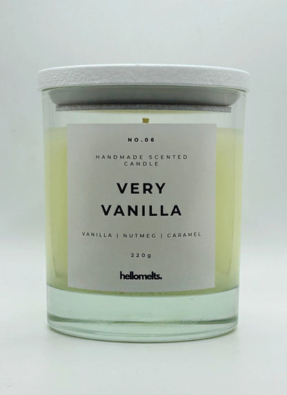 Very Vanilla 220g candle by Hellomelts, with lid on, infused with the warm scents of vanilla, nutmeg, and caramel, showcased in a simple white wax.