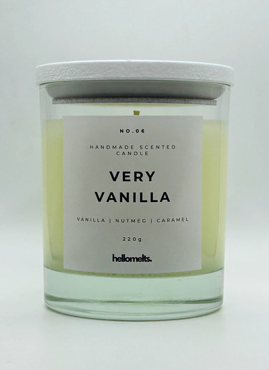 Very Vanilla 220g candle by Hellomelts, with lid on, infused with the warm scents of vanilla, nutmeg, and caramel, showcased in a simple white wax.