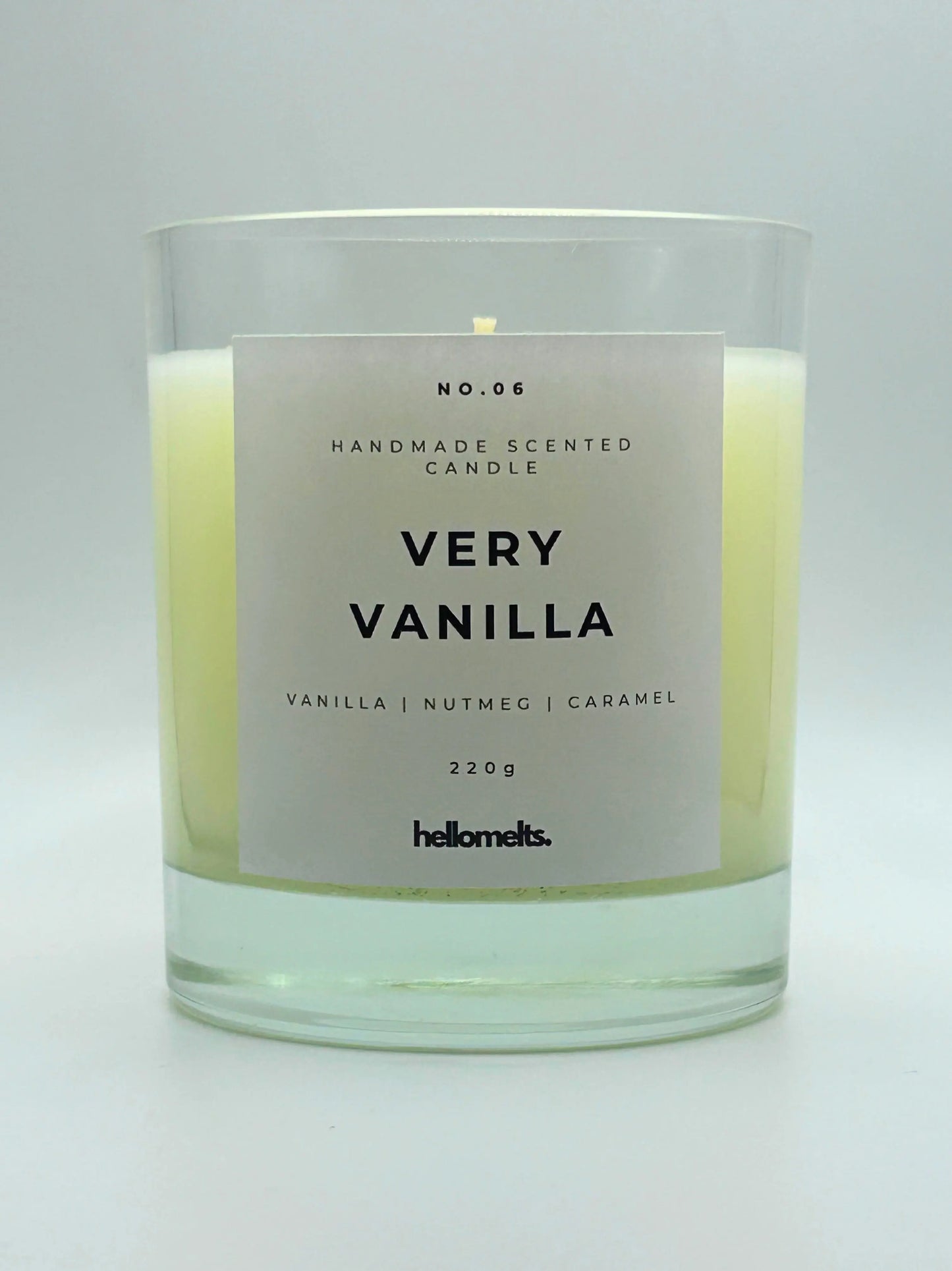 Very Vanilla 220g candle by Hellomelts, with no lid, infused with the warm scents of vanilla, nutmeg, and caramel, showcased in a simple white wax.