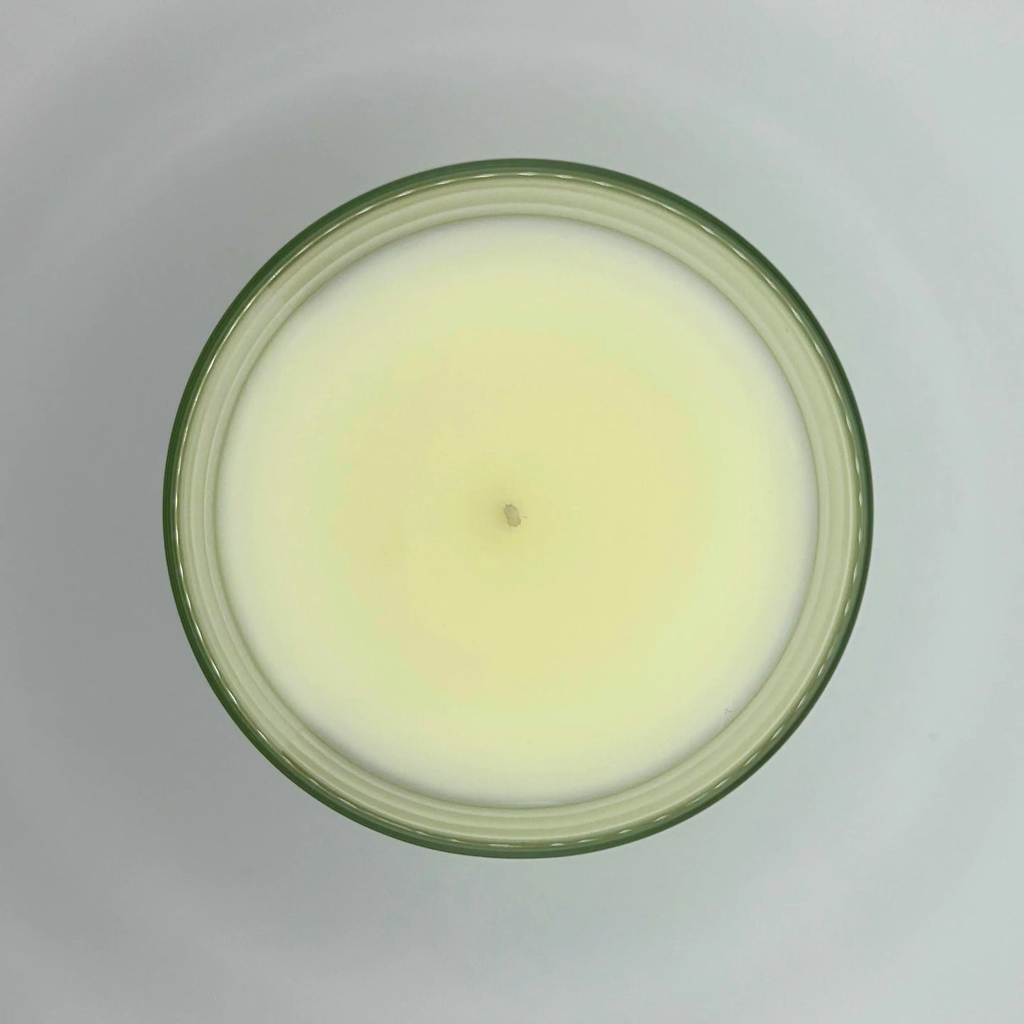 Very Vanilla 220g candle by Hellomelts, showing top view of wax, infused with the warm scents of vanilla, nutmeg, and caramel, showcased in a simple white wax.