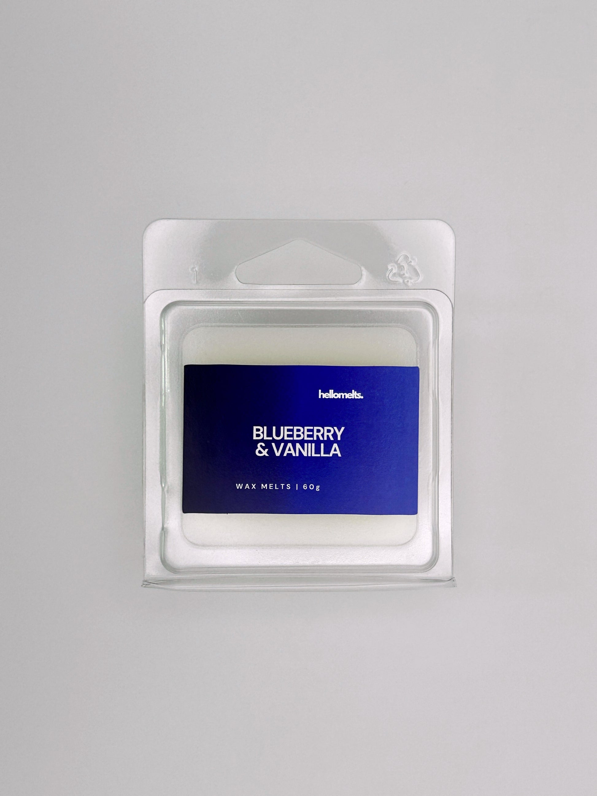 Flatlay of Blueberry & Vanilla 60g wax melt bar by Hellomelts, part of the Summer Collection with deep blue label colours and smooth wax finish