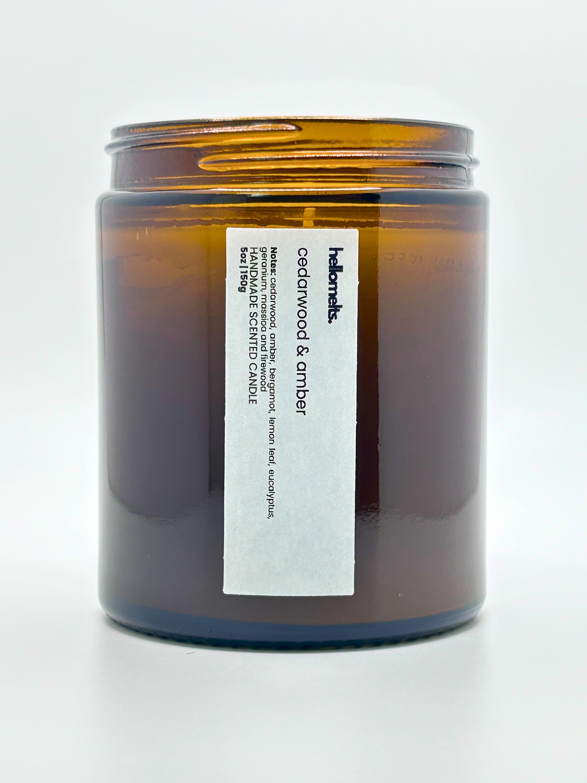 Close-up front view of Cedarwood &  Amber autumn scented candle by Hellomelts with the lid off, part of the Autumn Collection