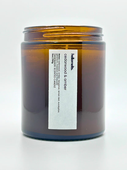 Close-up front view of Cedarwood &  Amber autumn scented candle by Hellomelts with the lid off, part of the Autumn Collection