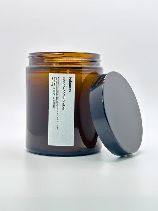 Front view of Cedarwood &  Amber autumn scented candle by Hellomelts with the lid placed beside it, part of the Autumn Collection