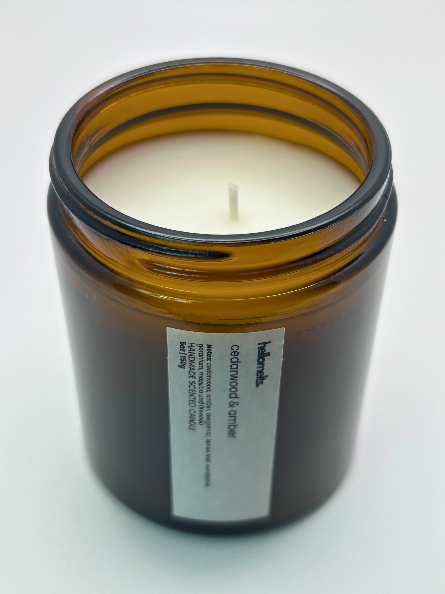 Angled top-down view of Cedarwood &  Amber autumn candle by Hellomelts, highlighting the wick and hand-poured wax, part of the Autumn Collection
