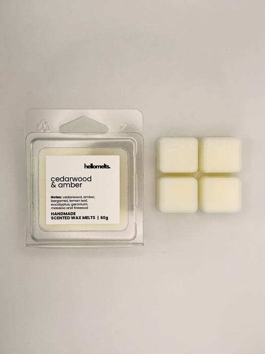 Cedarwood & Amber 60g wax melt bar displayed beside its clear clamshell packaging from the Hellomelts Autumn Collection