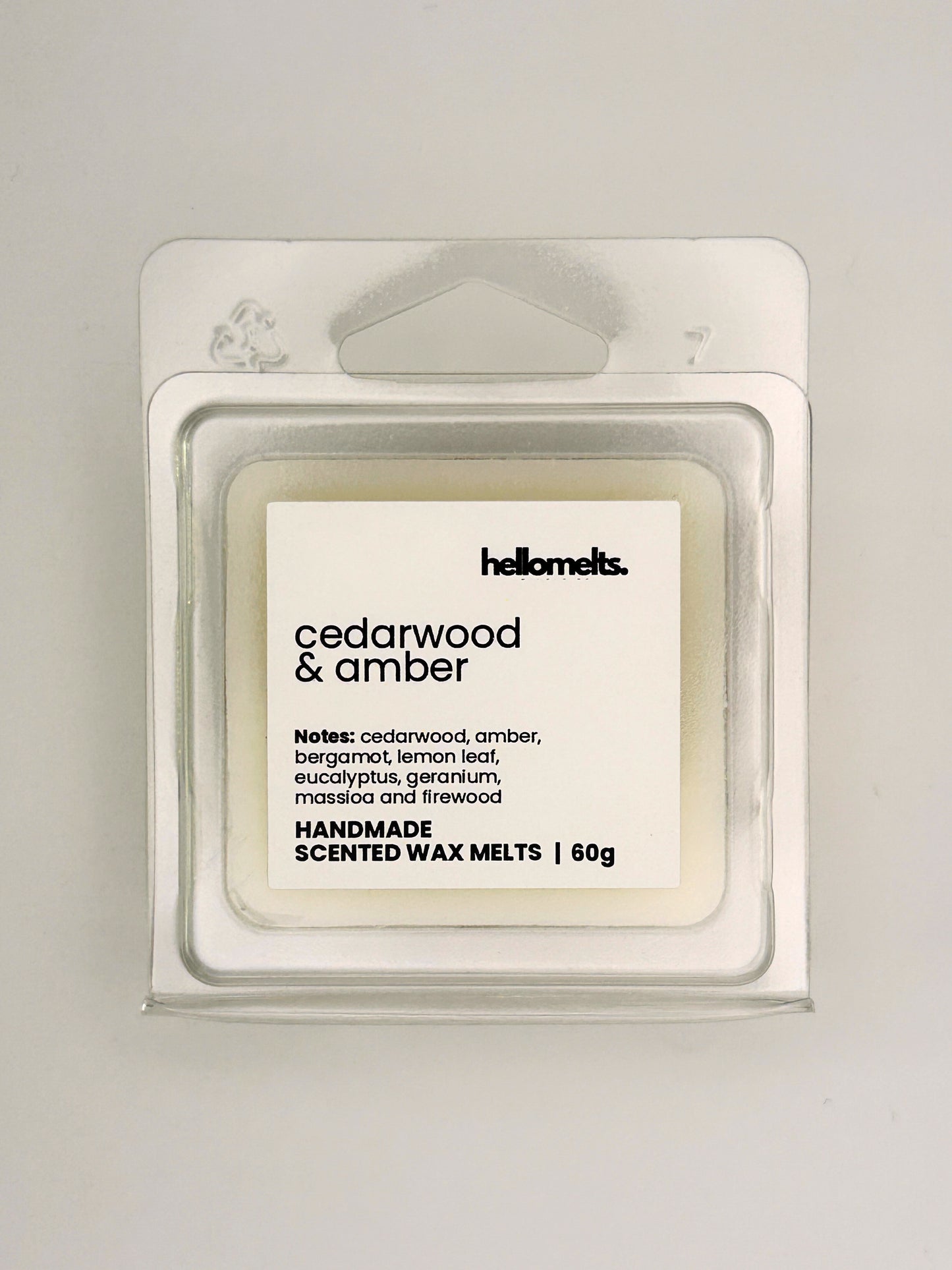 Close up of Cedarwood & Amber 60g wax melt label on clear clamshell packaging from the Hellomelts Autumn Collection