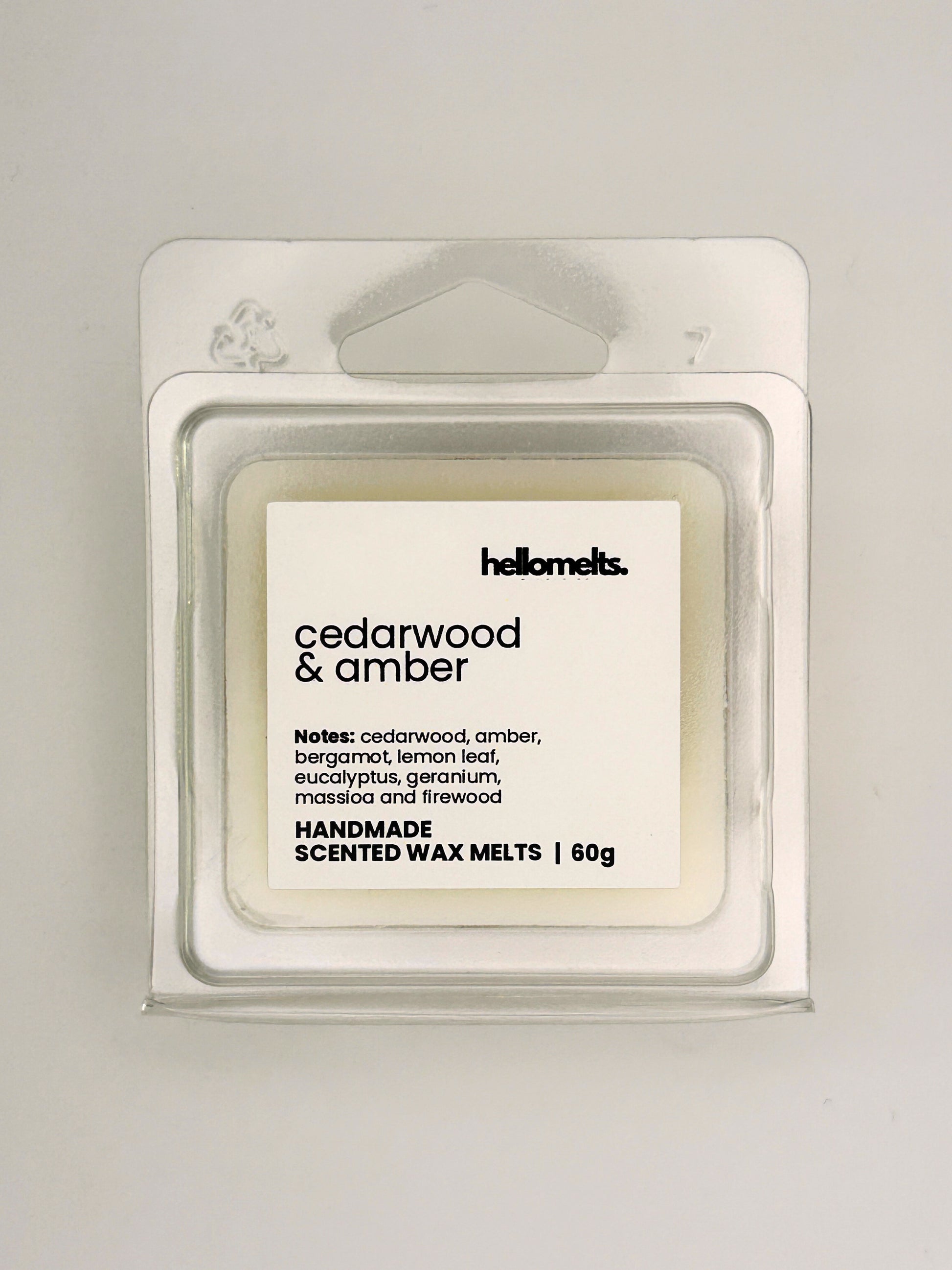Close up of Cedarwood & Amber 60g wax melt label on clear clamshell packaging from the Hellomelts Autumn Collection