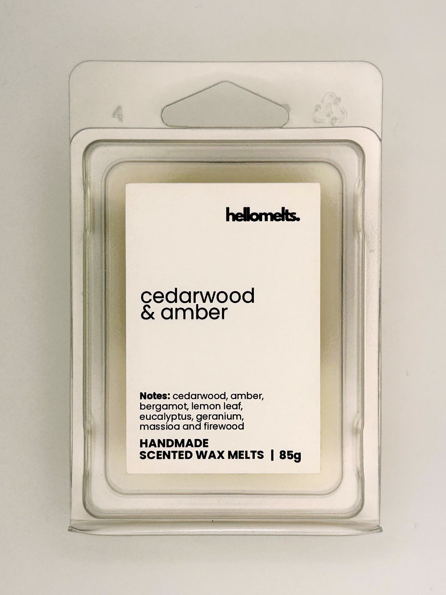 Close up of Cedarwood & Amber 85g wax melt label on clear clamshell packaging from the Hellomelts Autumn Collection