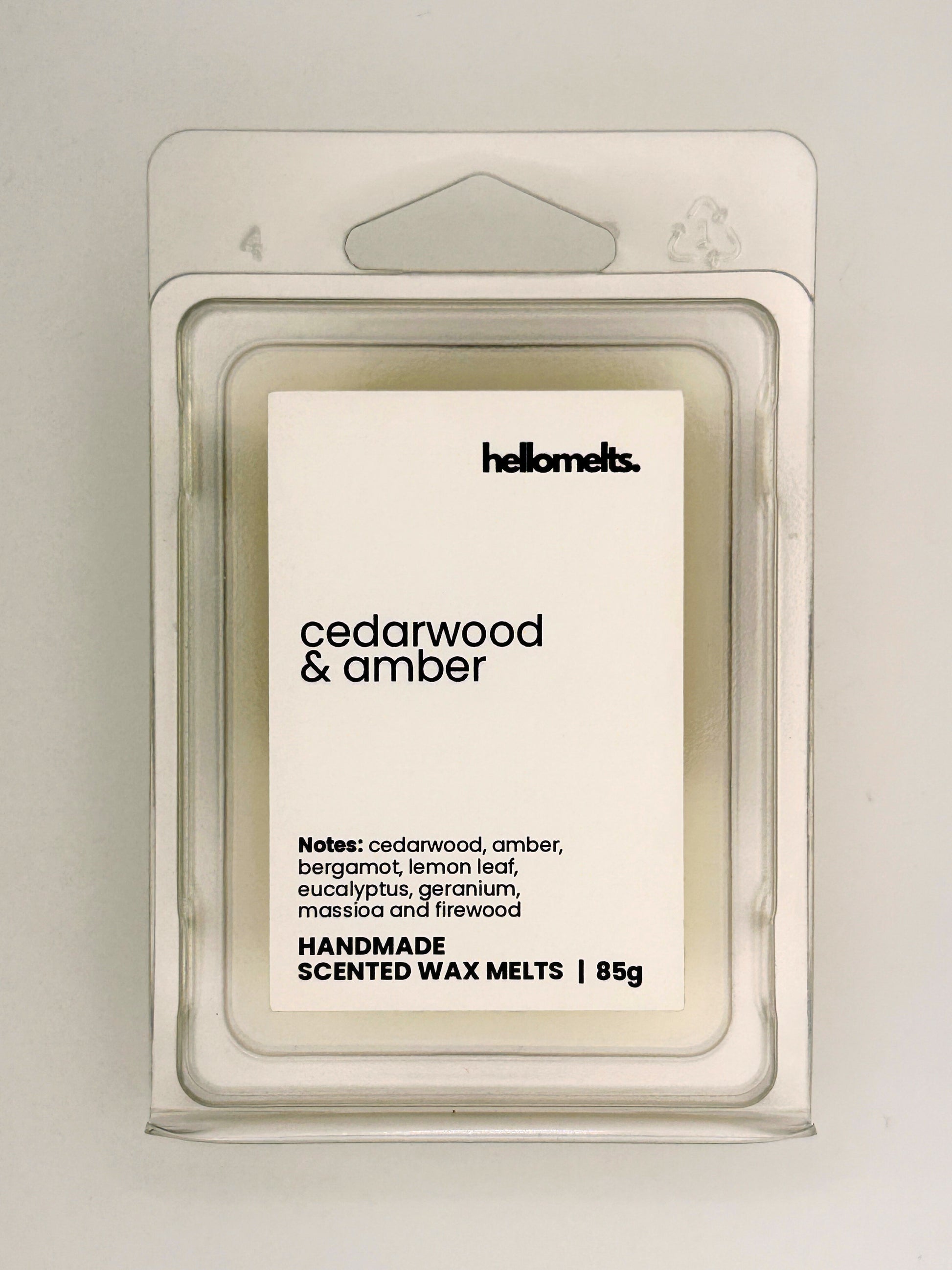 Close up of Cedarwood & Amber 85g wax melt label on clear clamshell packaging from the Hellomelts Autumn Collection