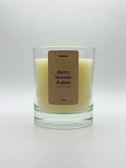 Front view of Cherry Blossom & Plum scented candle by Hellomelts, featuring a soft off-white wax in a clear glass jar, part of the Spring Collection.