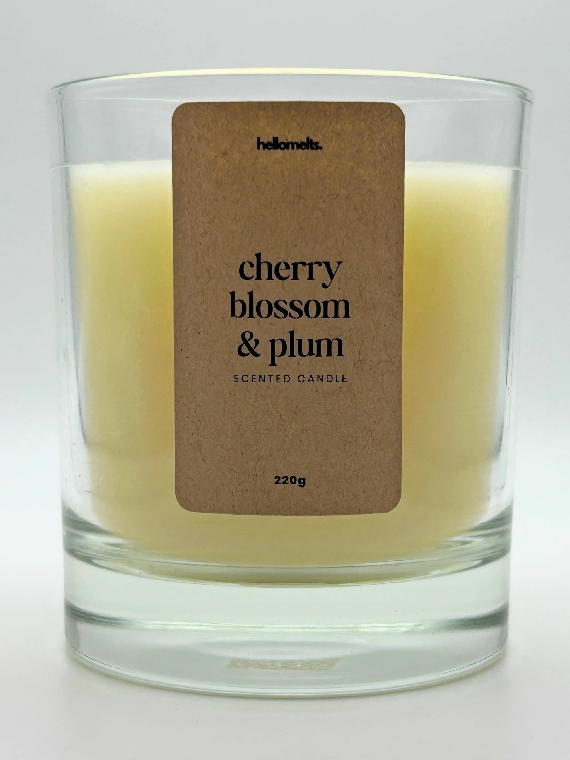 Close-up of the Cherry Blossom & Plum candle label showing scent name and weight, a handcrafted candle by Hellomelts for the Spring Collection.