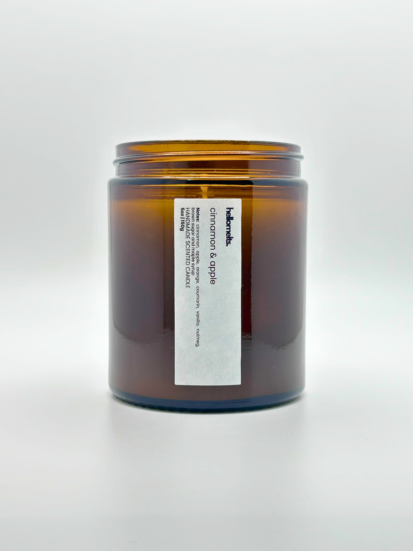 Front view of Cinnamon & Apple autumn scented candle by Hellomelts with the lid off, part of the Autumn Collection