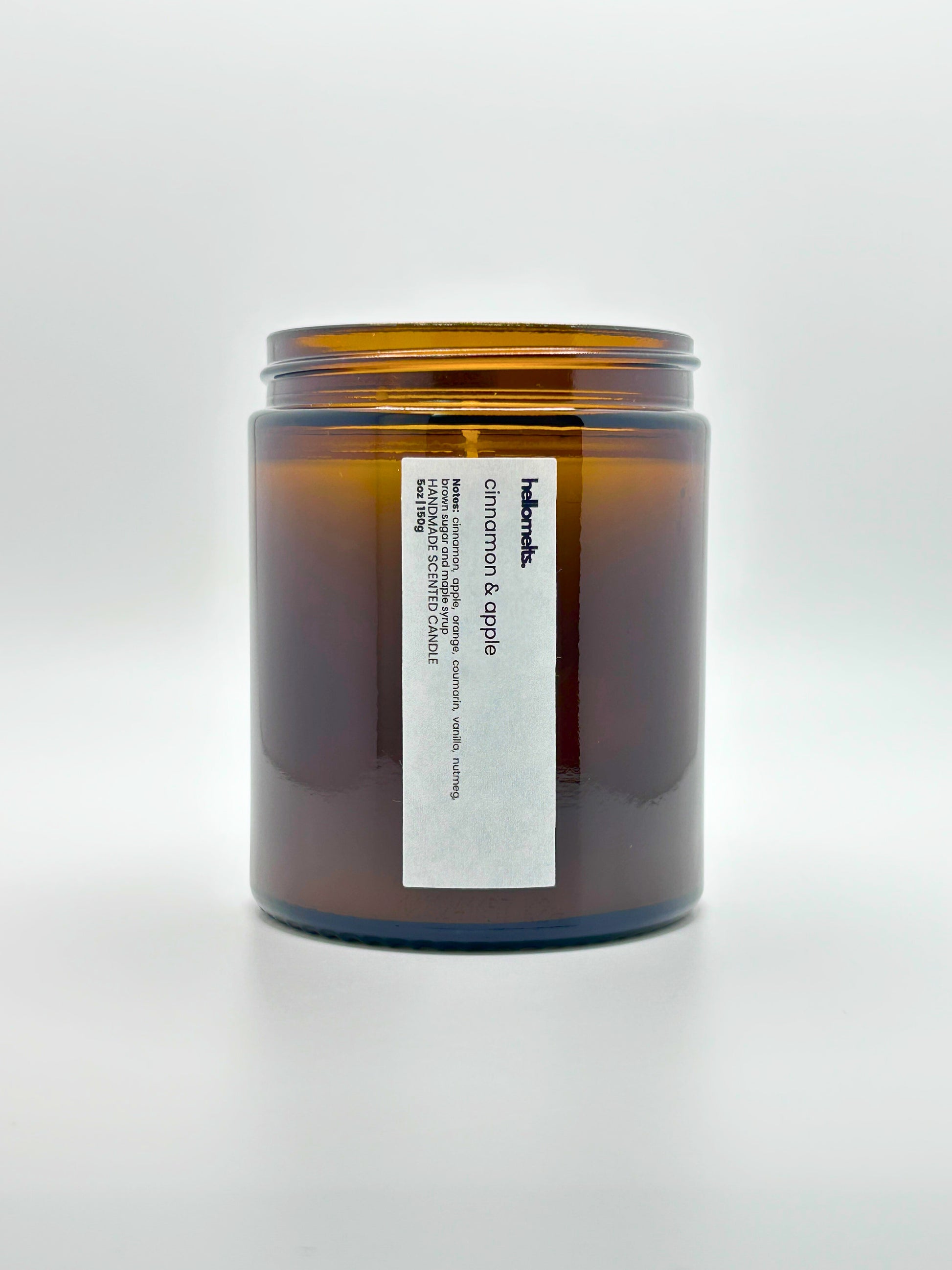 Front view of Cinnamon & Apple autumn scented candle by Hellomelts with the lid off, part of the Autumn Collection